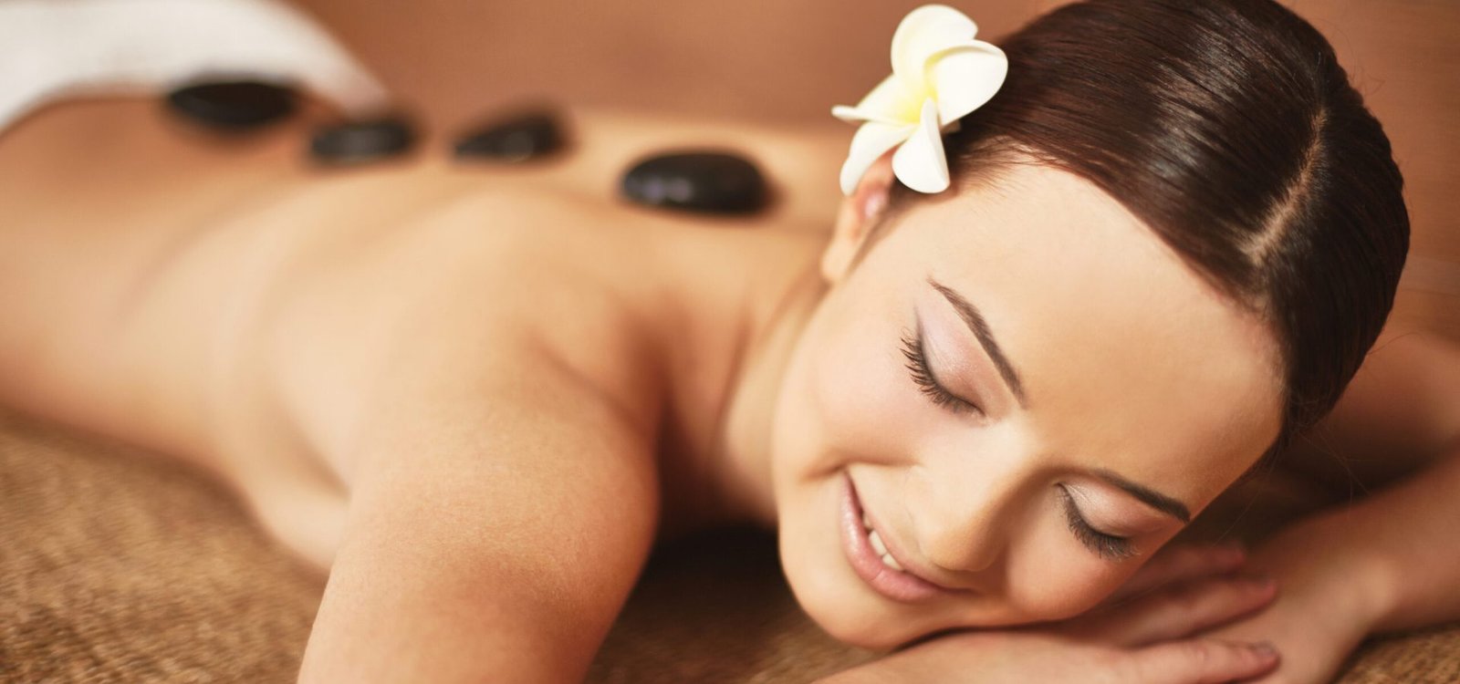 Portrait of young female enjoying spa procedure in beauty salon