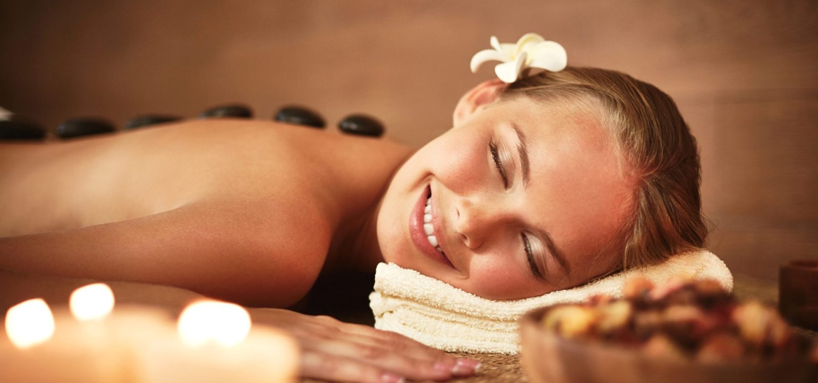 Portrait of young female enjoying spa procedure in beauty salon